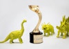 Three, green toy dinosaurs next to a Davey award