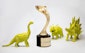 Three, green toy dinosaurs next to a Davey award